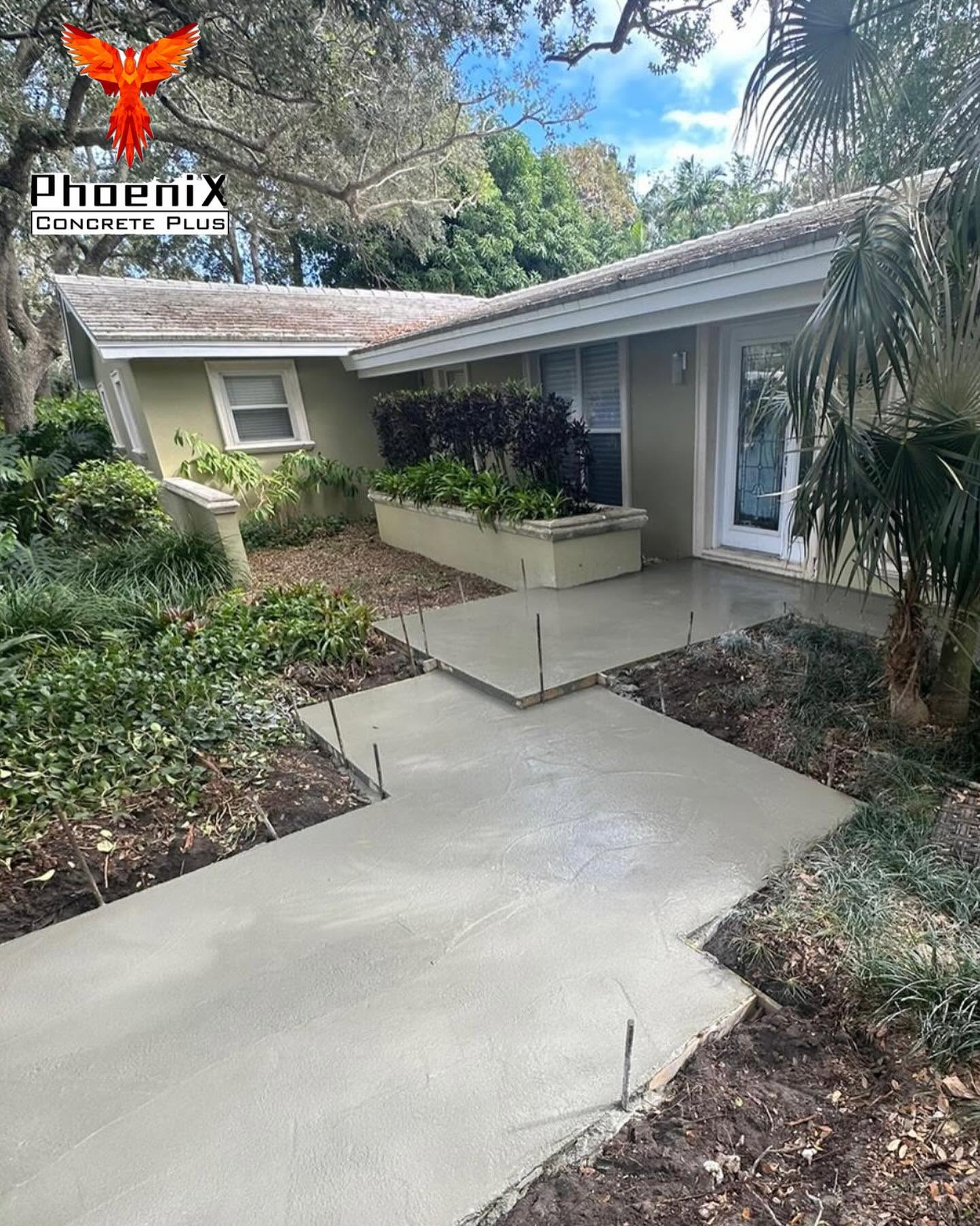 New concrete walkway and porch slab freshly poured at a Miami home, forms still in place